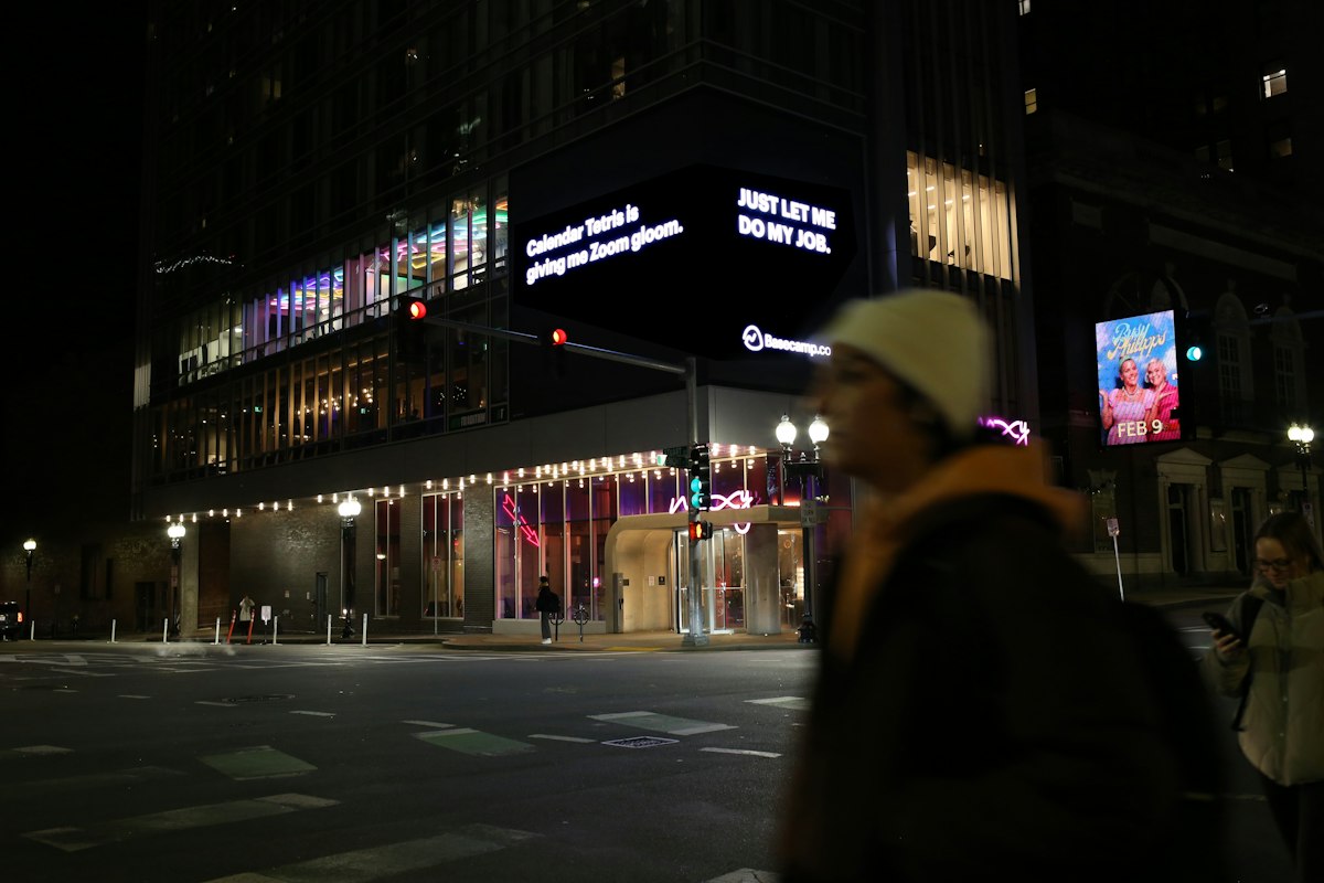 Digital billboards lighting up a city street at night
