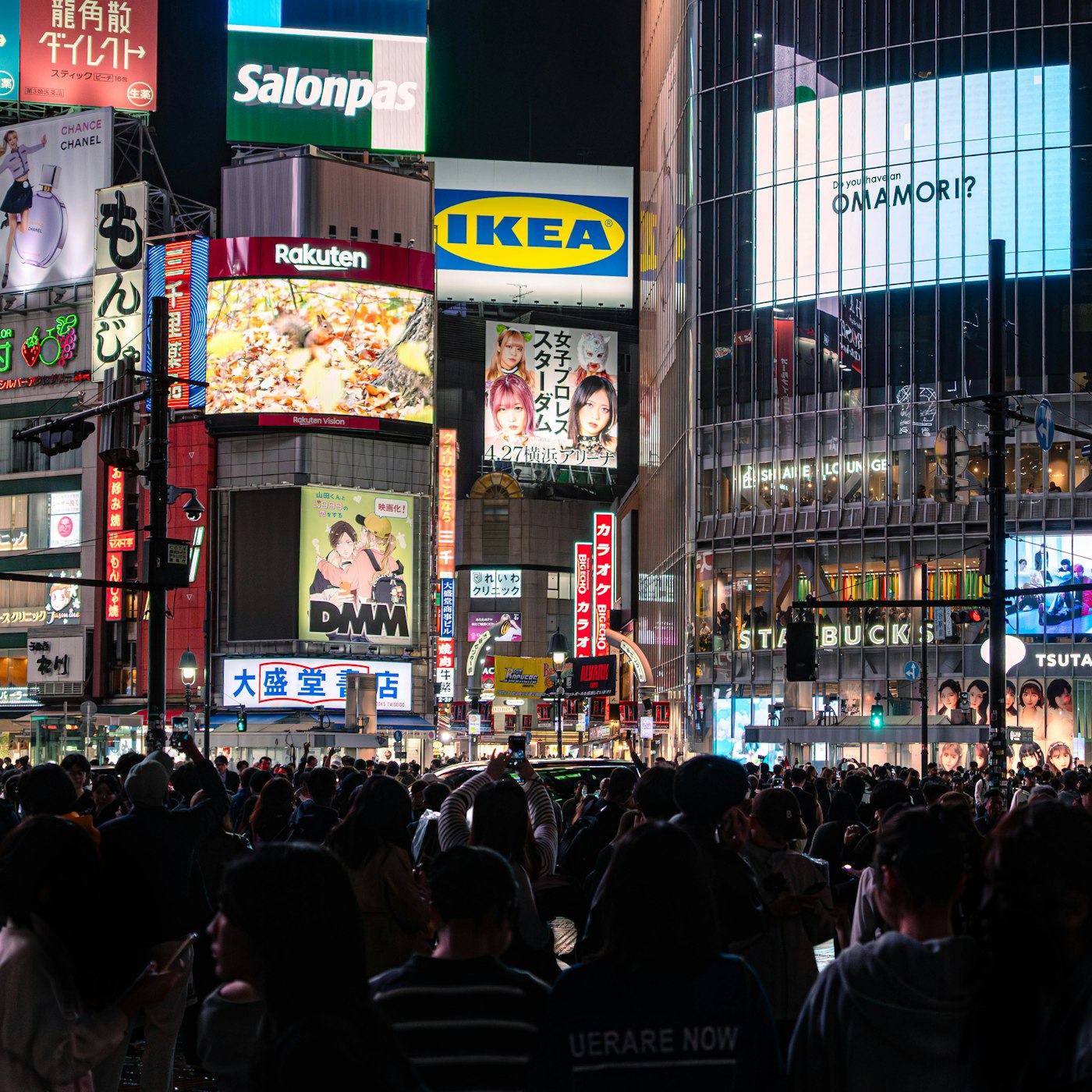 Illuminated billboards on a city street at night