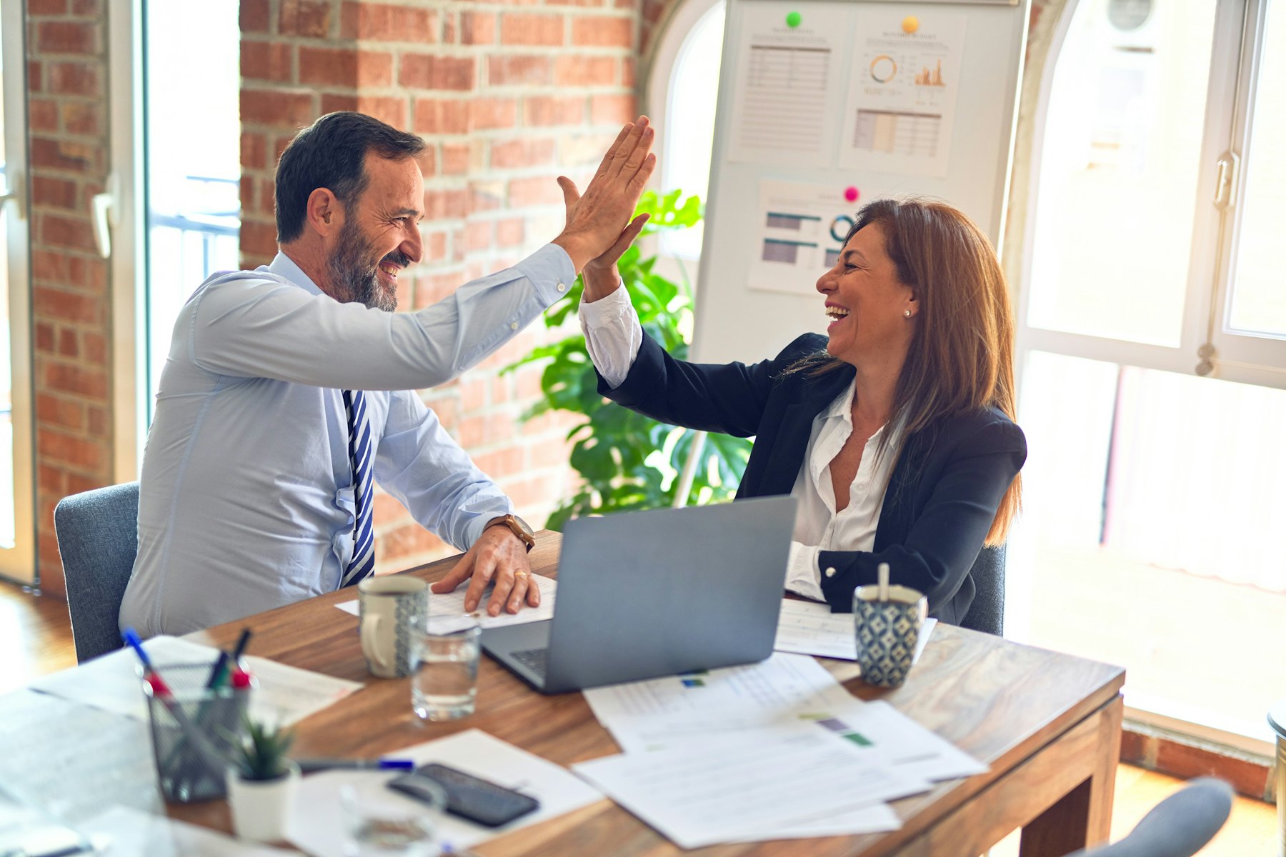 A sales team celebrating in a meeting