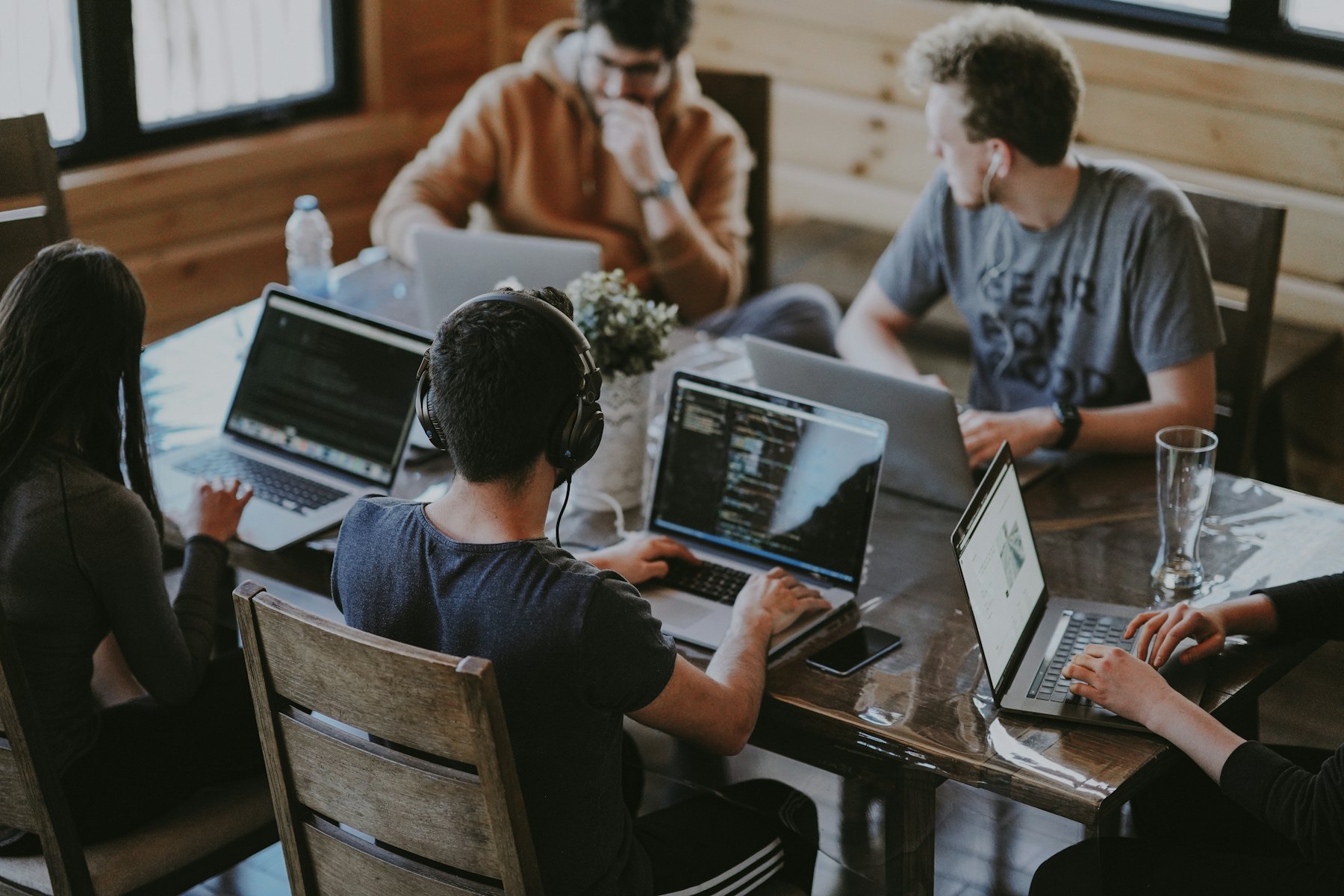 A team working together around a table with laptops