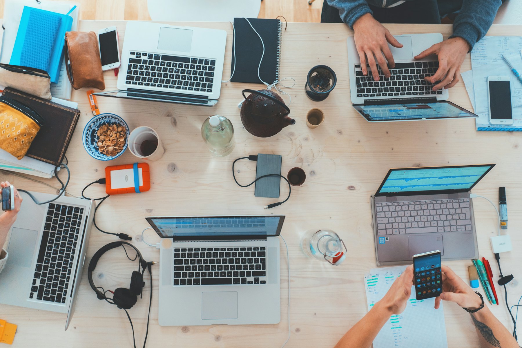 An overhead view of a team working on laptops