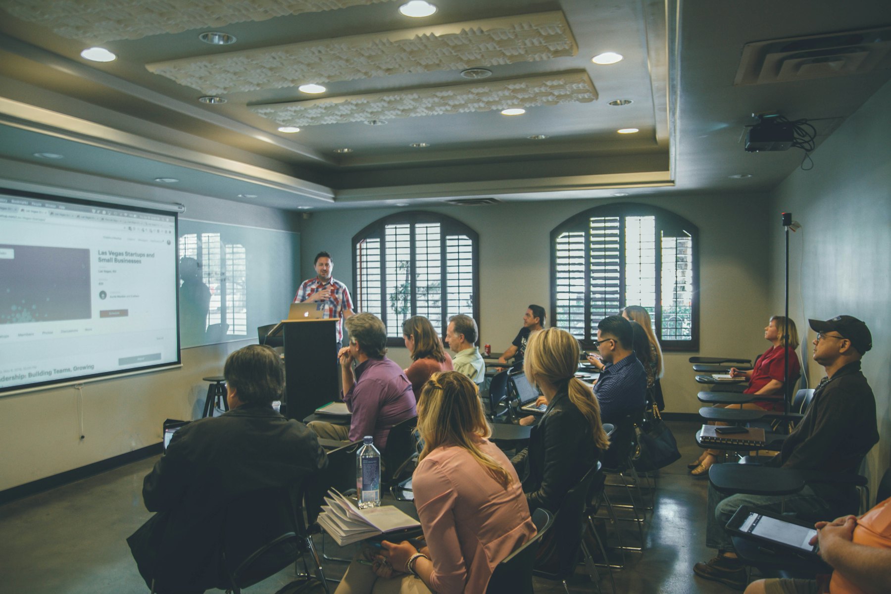 A group in a training session listening to a presenter